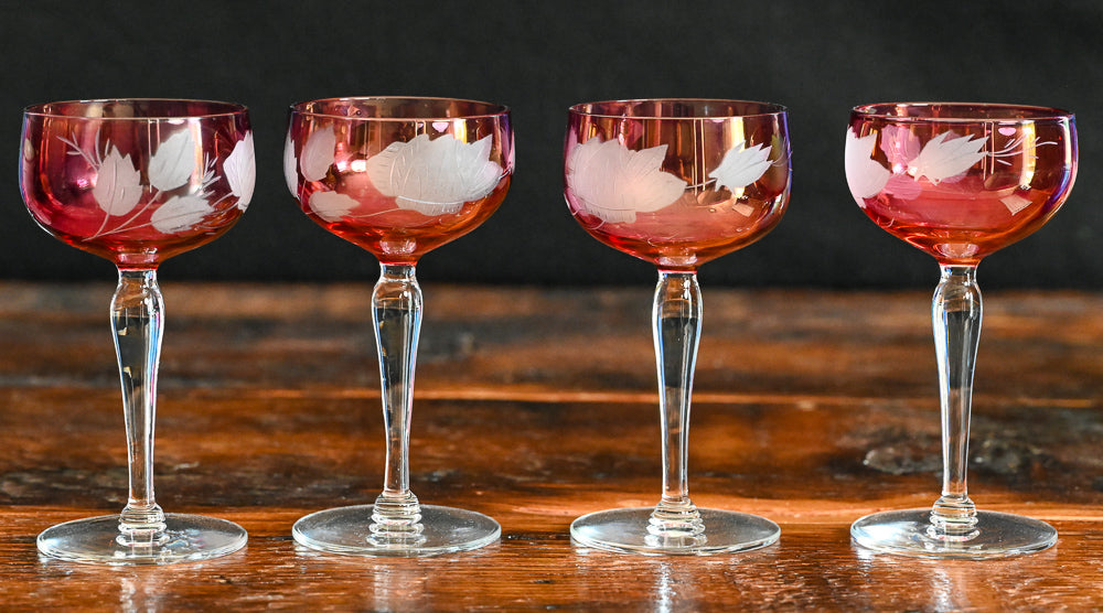 cranberry cocktail coupes with white frosted leaves
