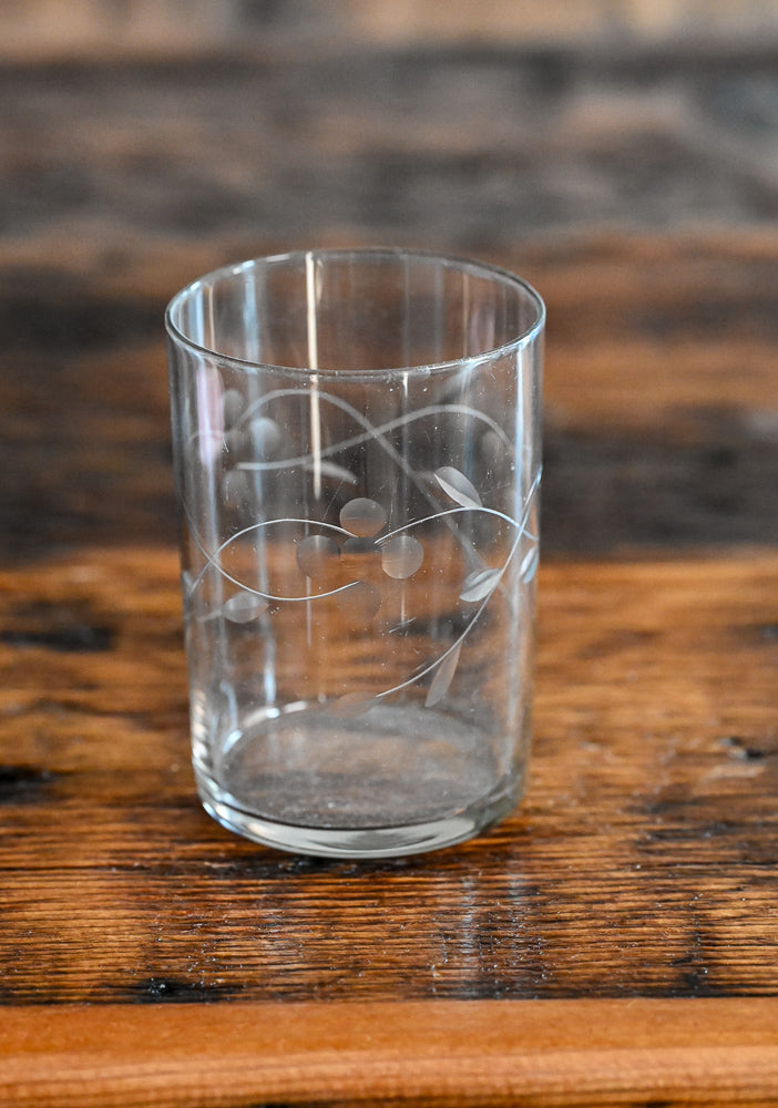 clear glass tumbler with flowers and leaves etched