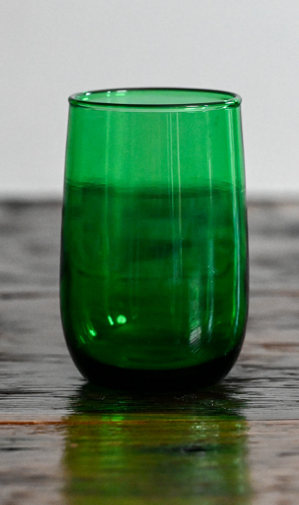 green glass on wooden table