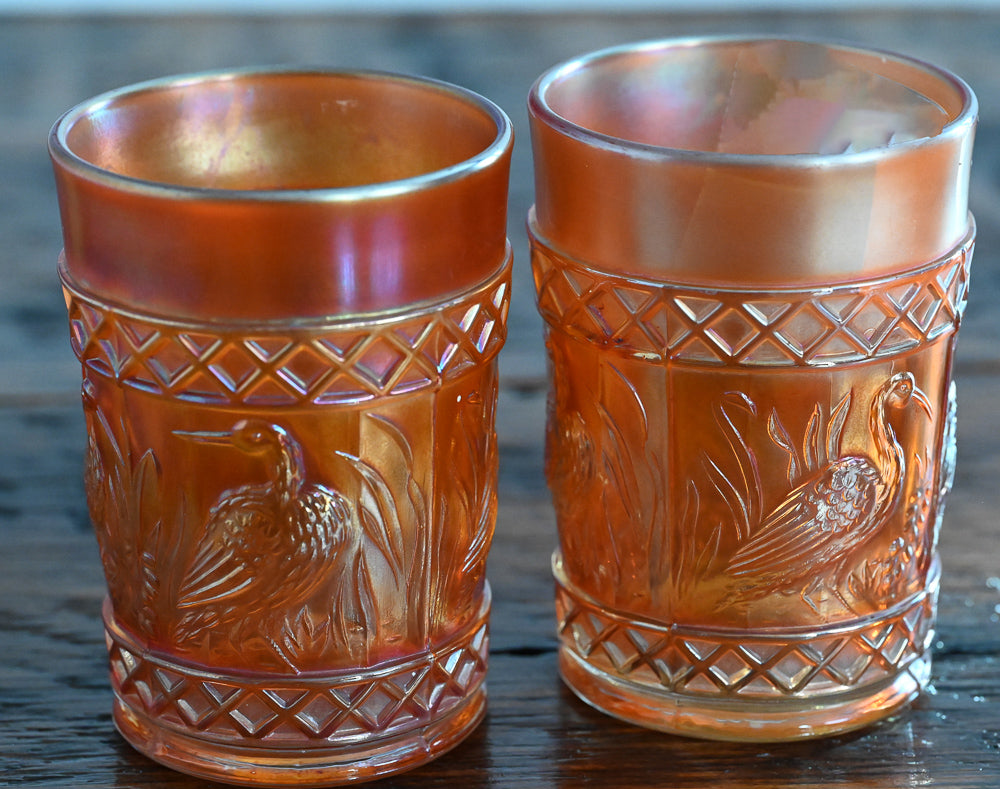 iridescent orange Carnival Glass stork tumblers