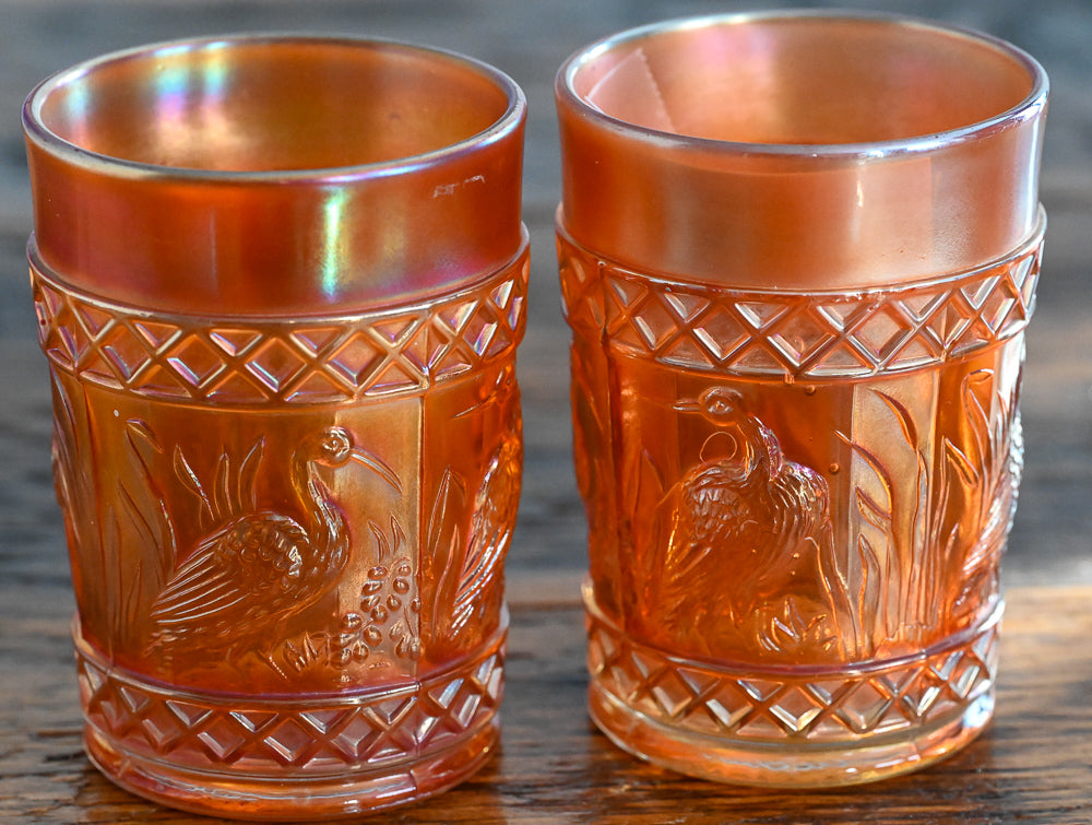 iridescent orange Carnival Glass stork tumblers
