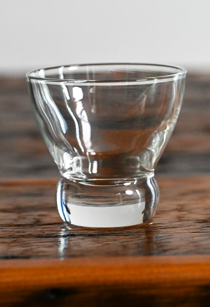 clear glass lowball on wood table