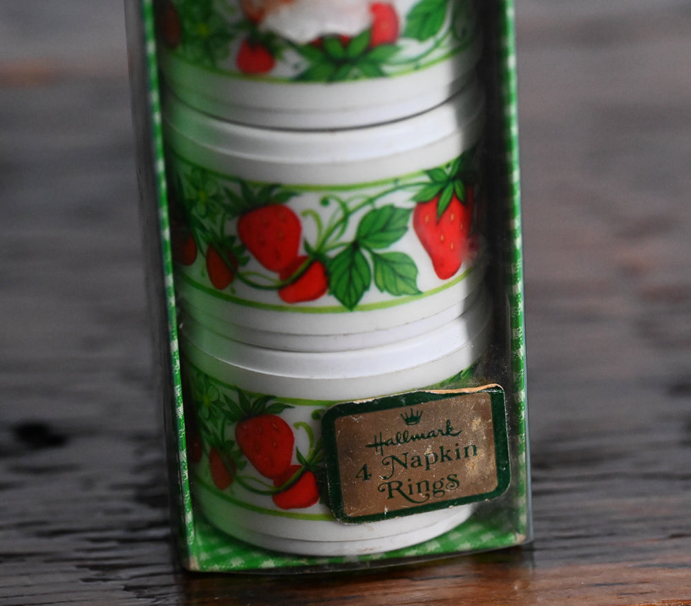 white plastic strawberry napkin rings in original container