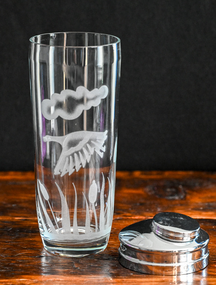 Etched duck, cloud and reeds on clear glass cocktail shaker with metal top