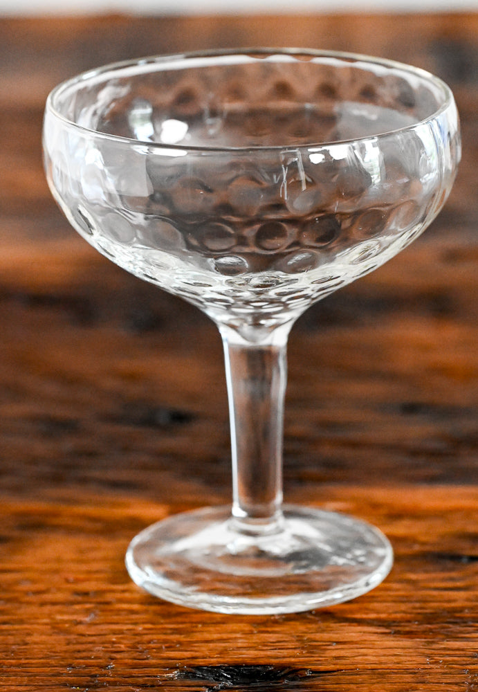 dimpled coupe on wood table