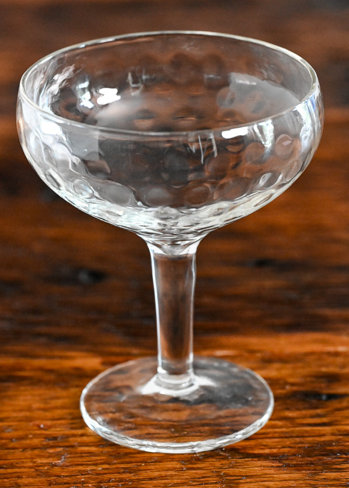 dimpled coupe on wood table