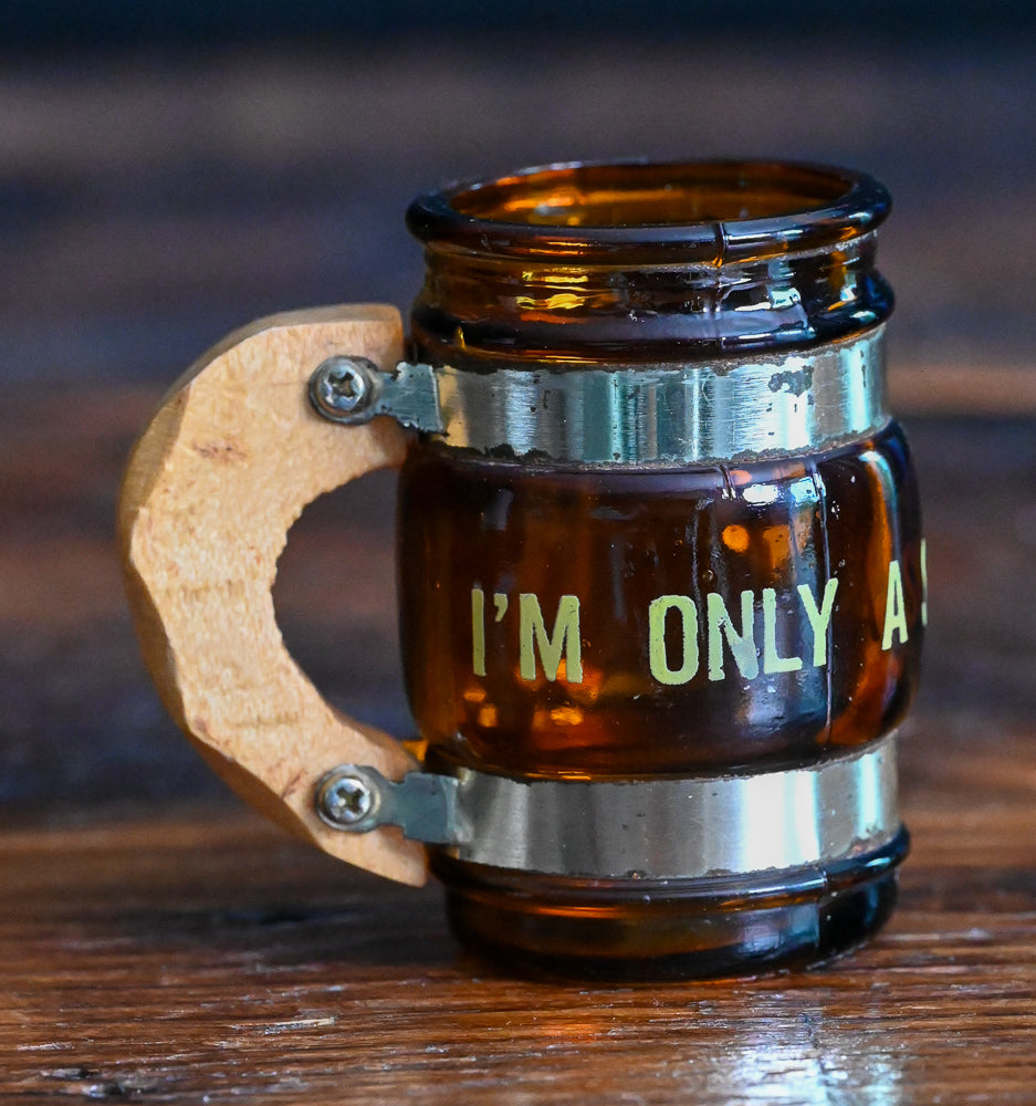 brown glass mug shotglass with wooden handle, says "small drinker"
