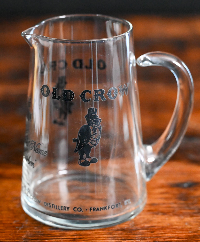 glass Old Crow pitcher with black writing and logo