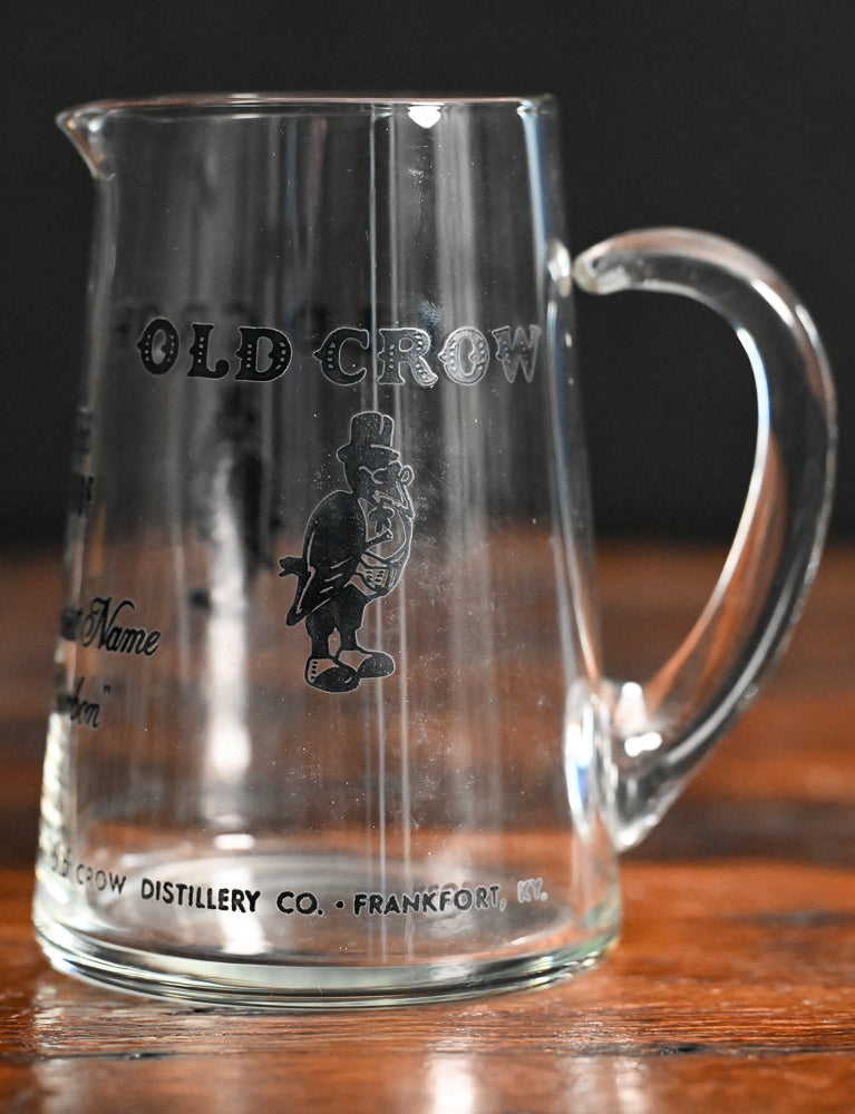 glass Old Crow pitcher with black writing and logo
