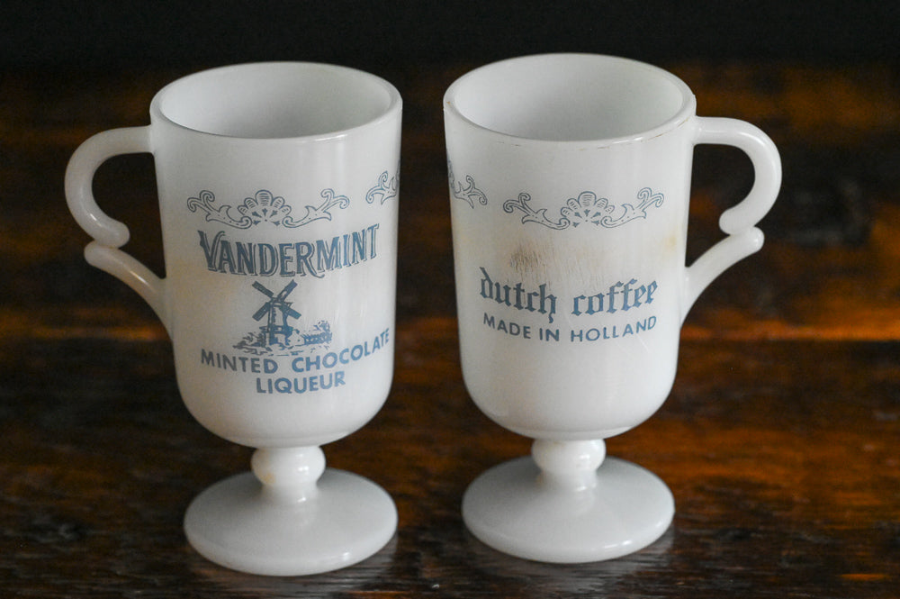 white milk glass Vandermint Mugs with blue writing and design