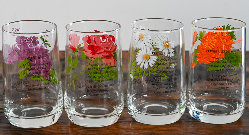 Flower of the month glasses on wooden table