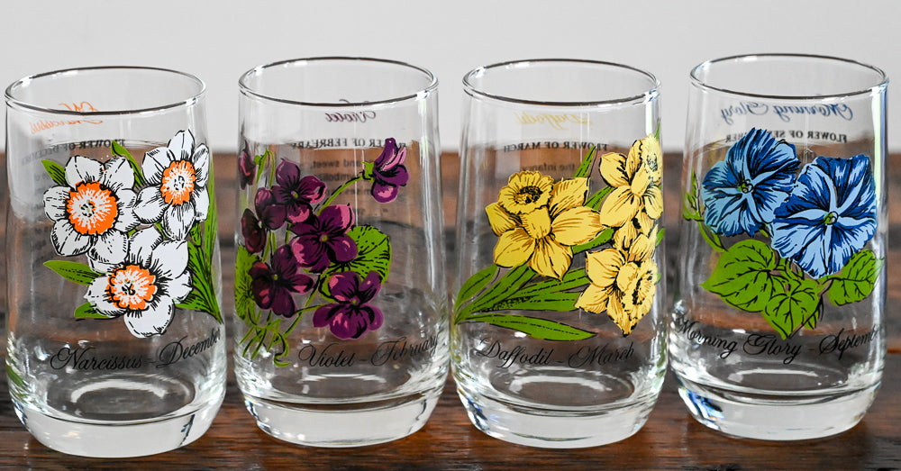 Flower of the month glasses on wooden table