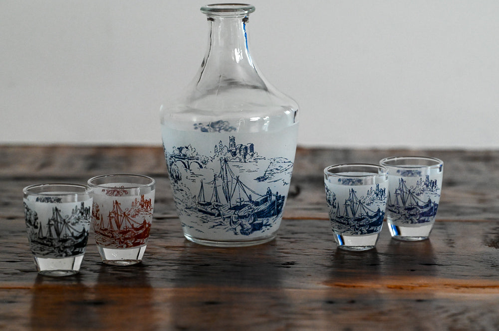 decanter and shot glasses on wood table