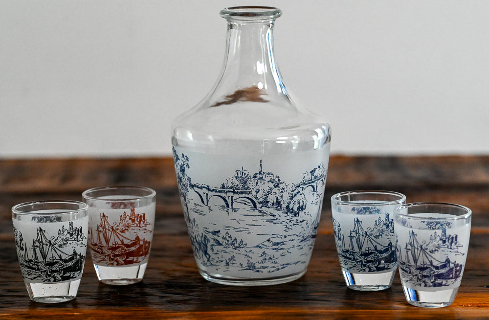 decanter and shot glasses on wood table
