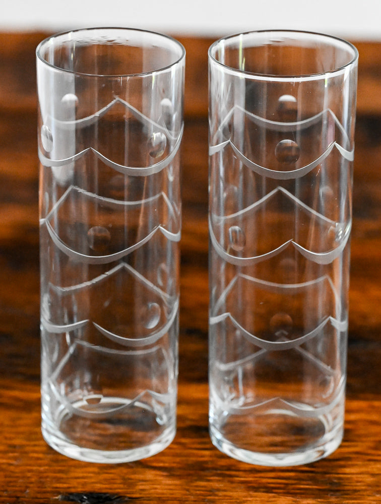 Etched highball glasses on wood table