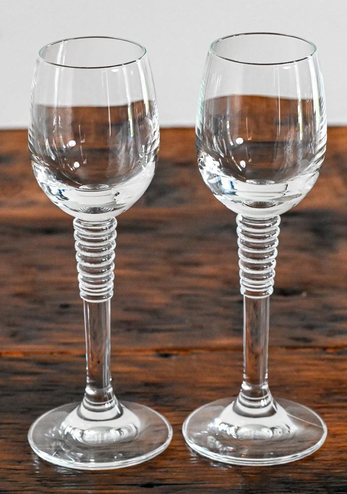 cordial glass with stacked stem on wood table