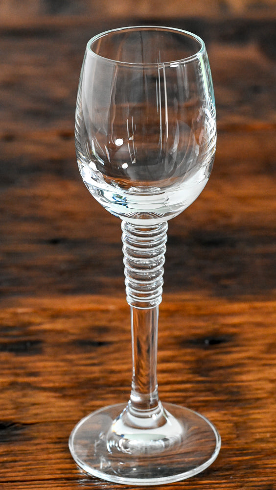 cordial glass with stacked stem on wood table