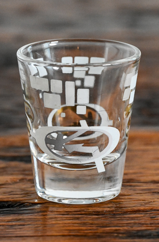 white and gold MCM logo shot glass