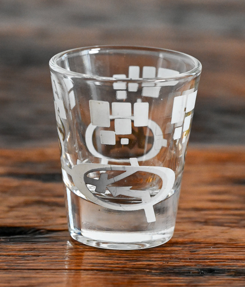 white and gold MCM logo shot glass