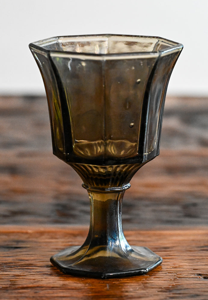 smoke brown goblet on wooden table