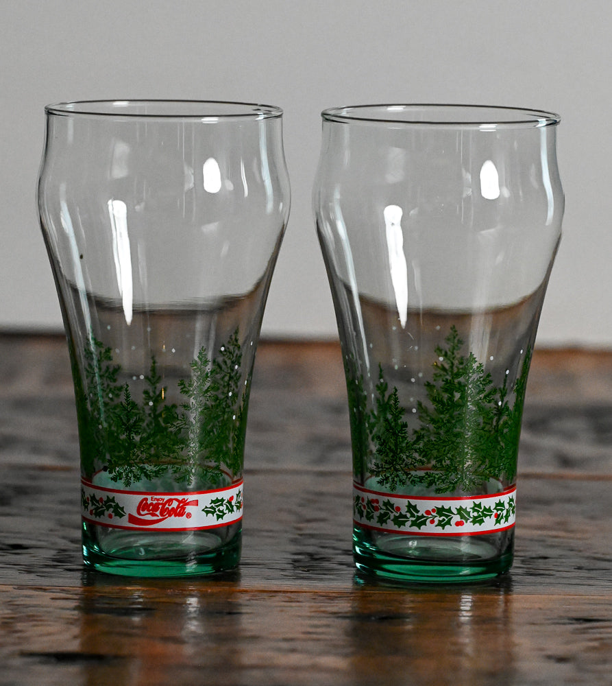 green glass with green trees and white strip with holly leaves, red Coca-Cola logo