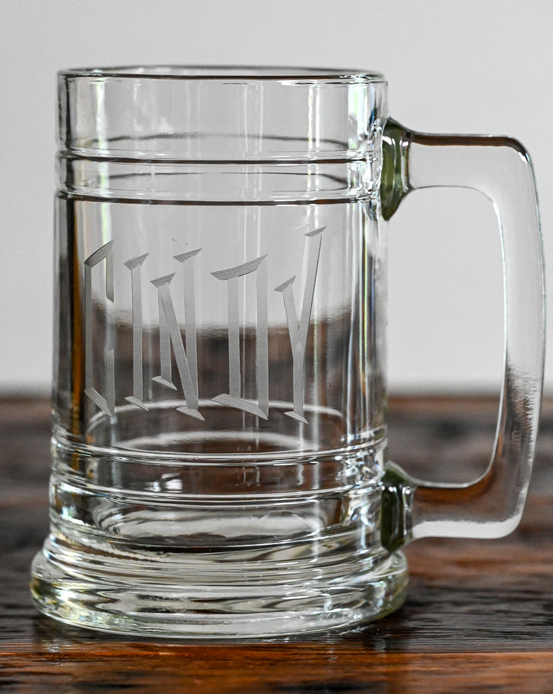 Clear Beer stein etched with "cindy" on wooden table