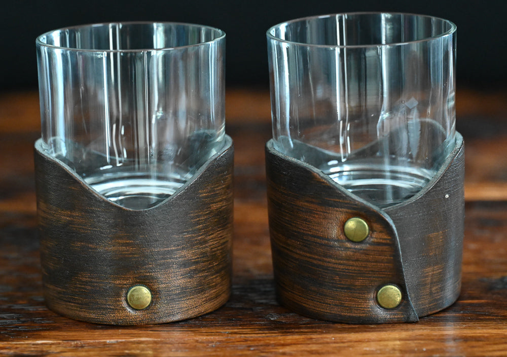 clear rocks glass sitting in leather holder