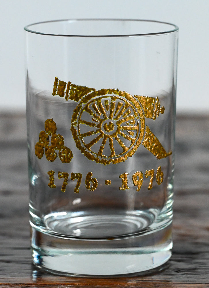 gold cannon and 1776-1976 on clear double rocks glass