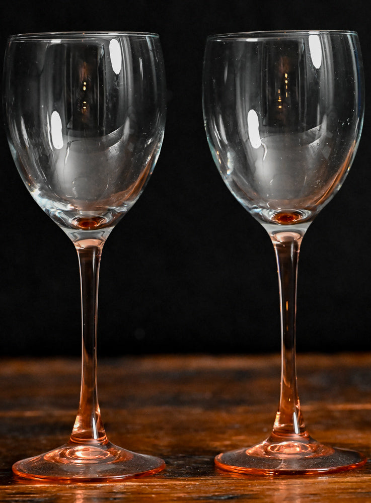 clear wine glass with pink glass stem