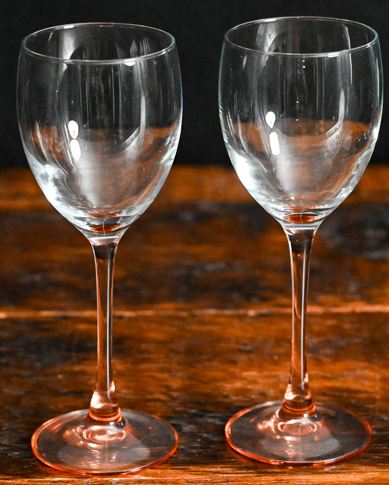 clear wine glass with pink glass stem
