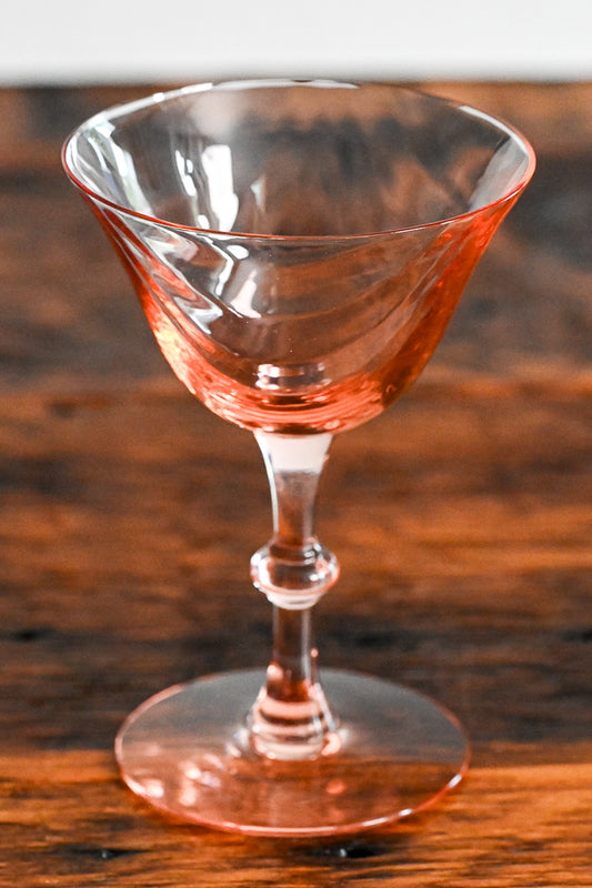pink coupe on wooden table