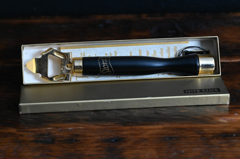 Storz black and 24K gold Nite Club bottle opener, with gold box