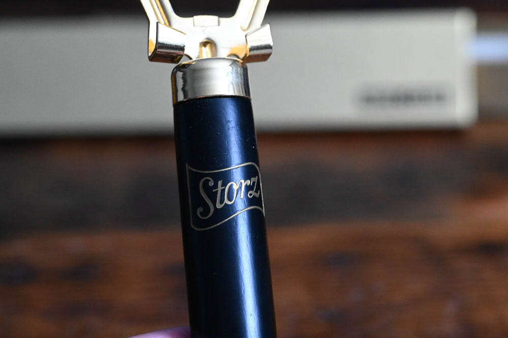 Storz black and 24K gold Nite Club bottle opener, with gold box