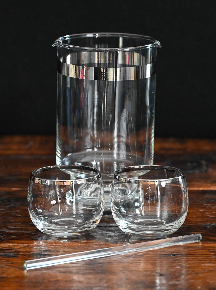 silver banded cocktail pitcher, glass cocktail stirrer and 6 silver rim roly poly glasses