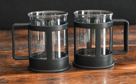 clear glass coffee mugs with black plastic handles and holders