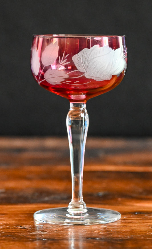 cranberry cocktail coupes with white frosted leaves