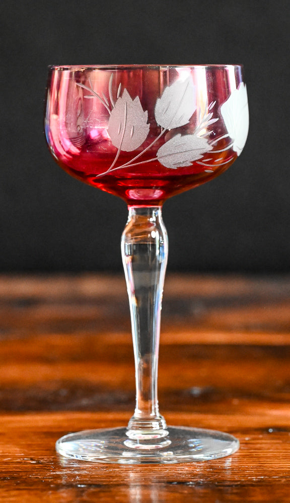 cranberry cocktail coupes with white frosted leaves