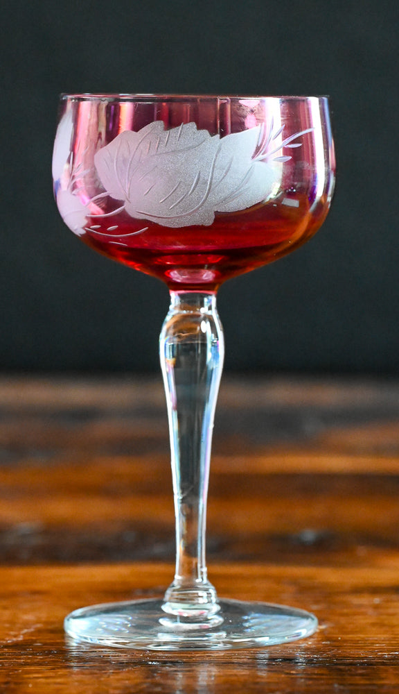 cranberry cocktail coupes with white frosted leaves