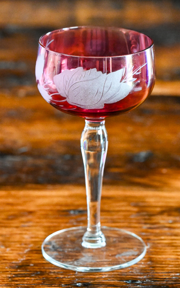 cranberry cocktail coupes with white frosted leaves