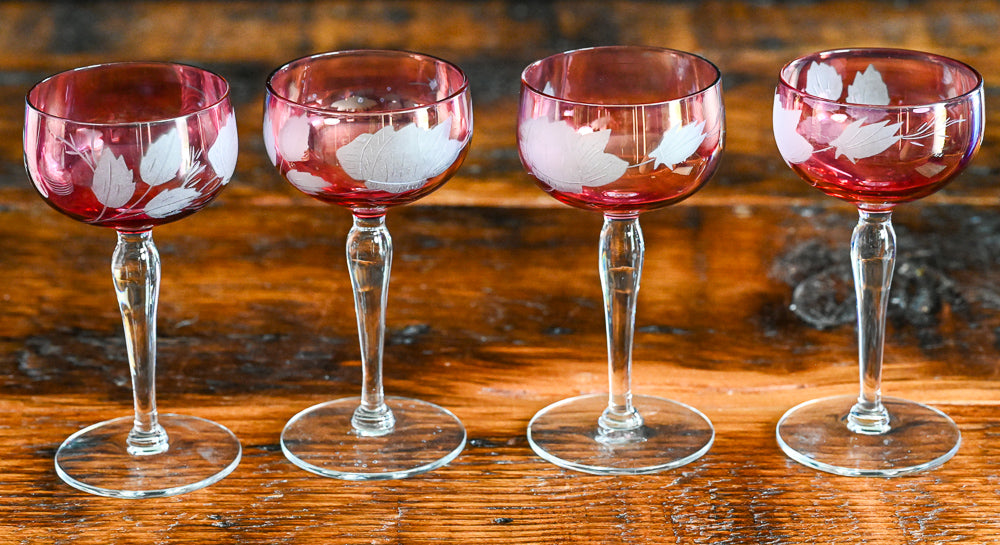 cranberry cocktail coupes with white frosted leaves