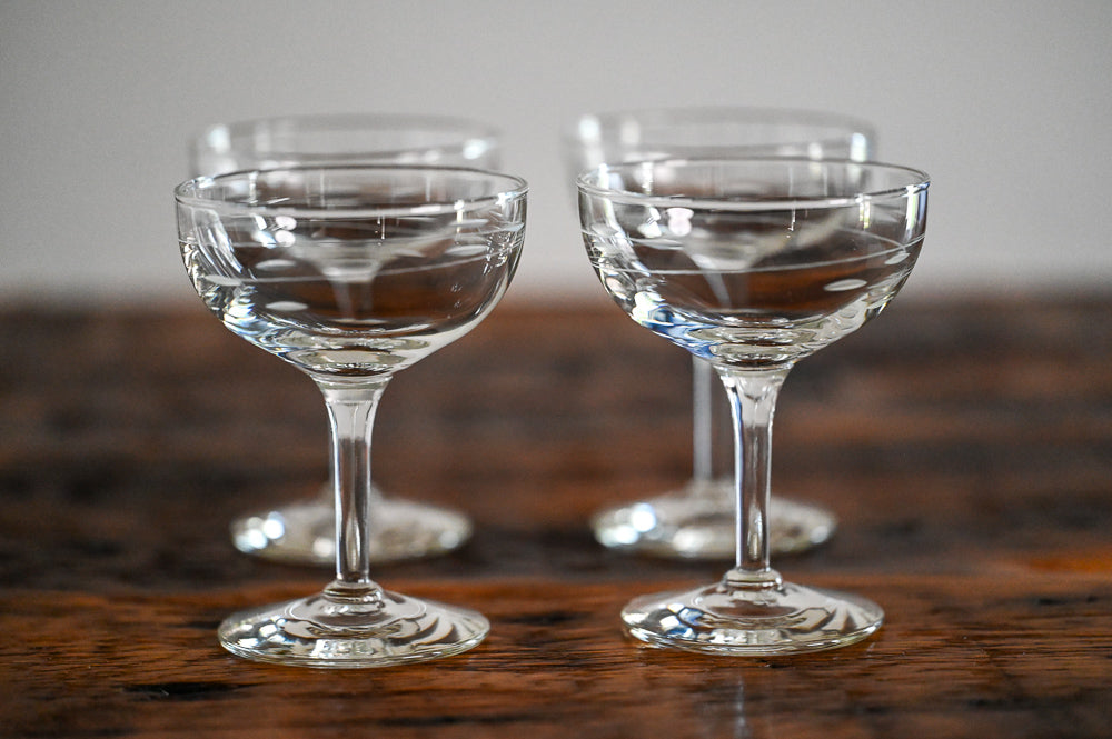 Libbey etched coupes on wood table