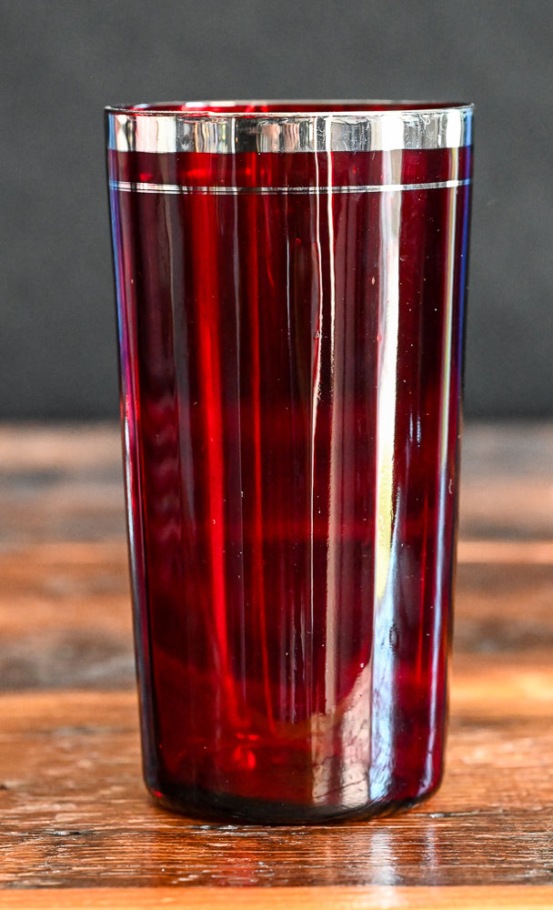 ruby red tumbler with silver rim and band