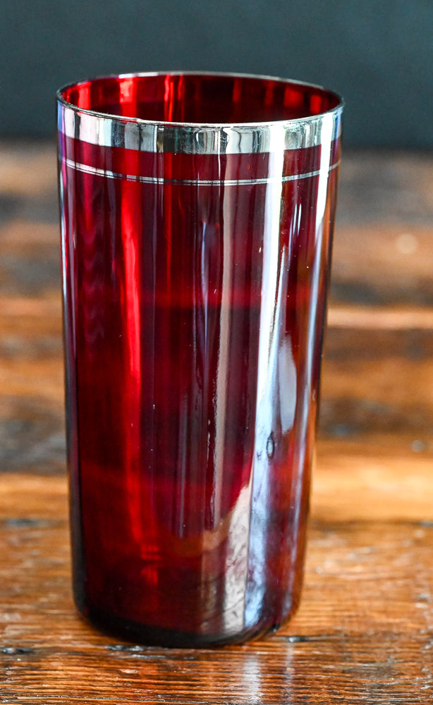 ruby red tumbler with silver rim and band