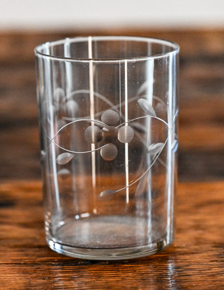 clear glass tumbler with flowers and leaves etched