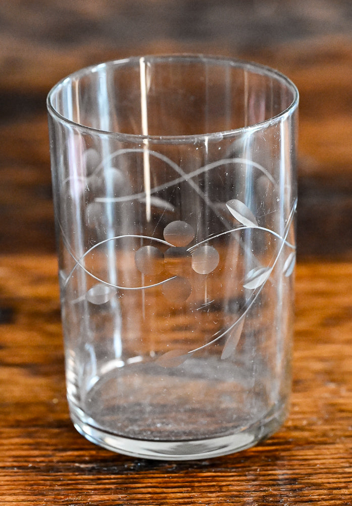 clear glass tumbler with flowers and leaves etched