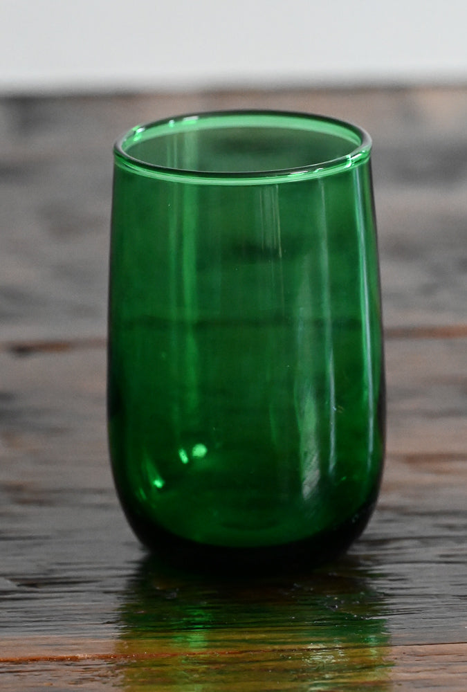 green glass on wooden table
