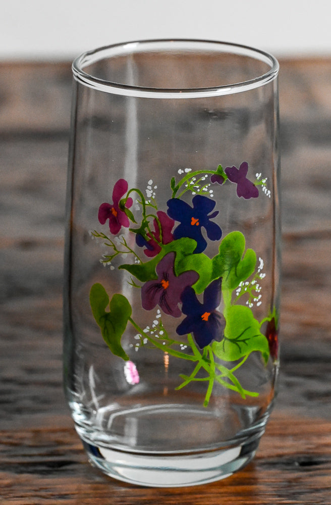 Avon purple flowers and green leaves on clear tumbler