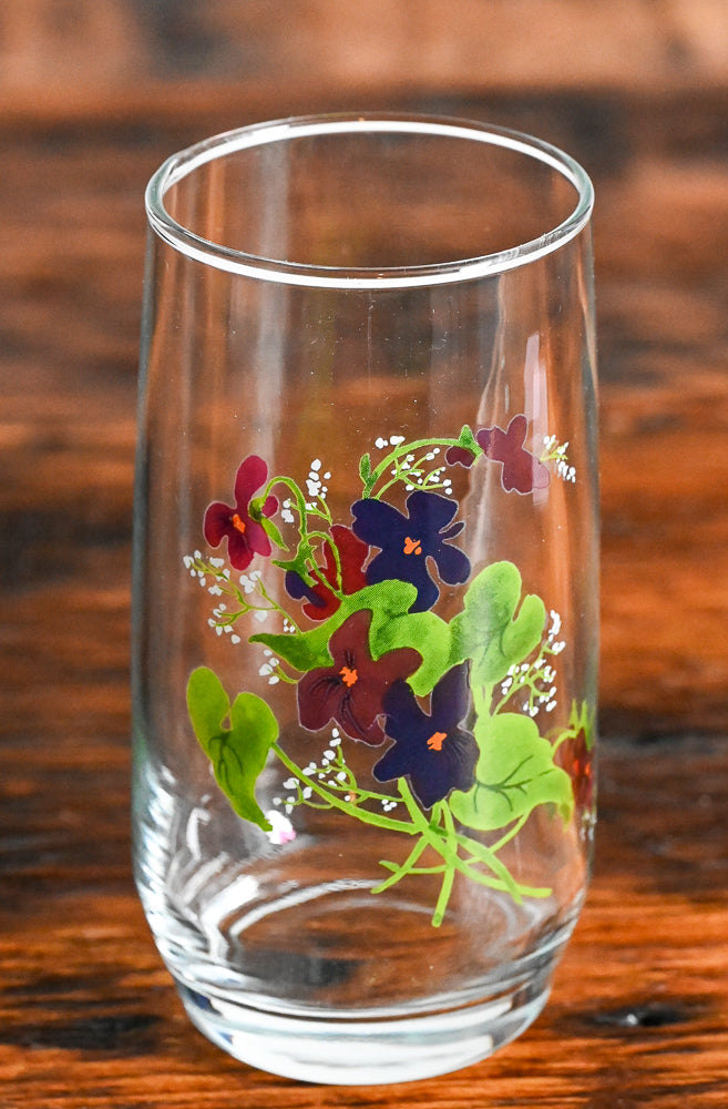 Avon purple flowers and green leaves on clear tumbler