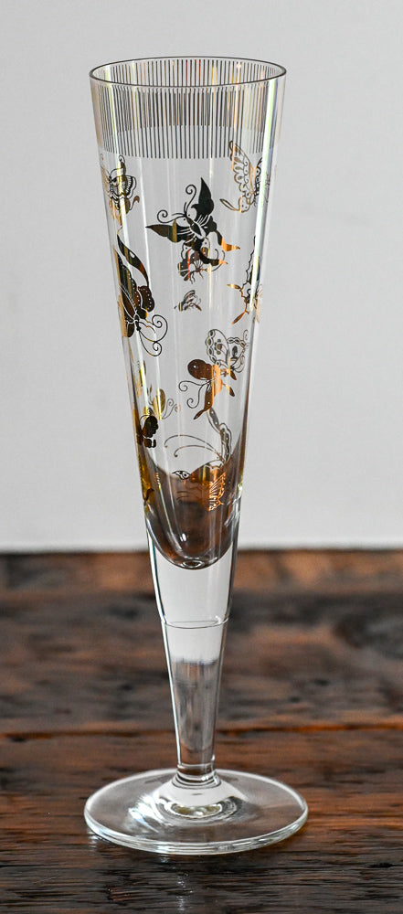 gold butterfly pattern on tall clear glass