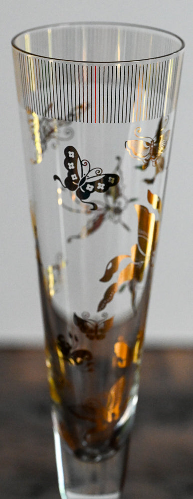 gold butterfly pattern on tall clear glass